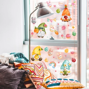 Detailed view of Easter gnome window stickers with rabbits and eggs on a glass surface