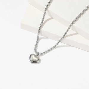 Polished silver heart pendant on shimmering crystal tennis chain necklace