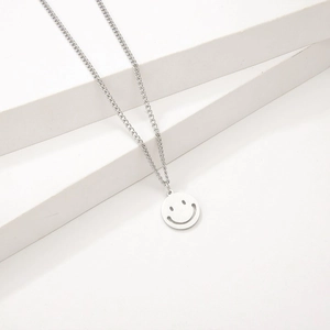 Minimalist silver titanium steel necklace featuring a hollow smiley face pendant charm