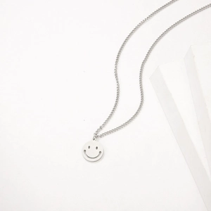 Minimalist titanium steel necklace with a round hollow smiley pendant on a thin silver chain