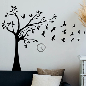Detail of black tree and bird silhouette wall stickers in a modern living room setting