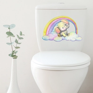 Detail of cartoon elephant and rainbow waterproof sticker on a white ceramic toilet tank