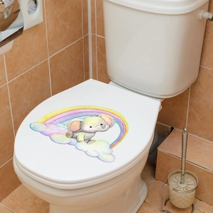 Detailed view of cartoon elephant and rainbow sticker on a white toilet lid for bathroom decor