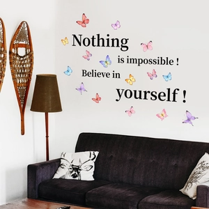 Detailed view of motivational quotes and 3D colorful butterflies wall stickers on a white wall