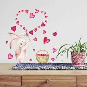Watercolor bunny wall sticker with glowing hearts forming a large heart shape on a white wall