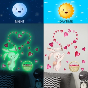 Luminous wall sticker with cartoon bunny and hearts showing day and night glowing effects