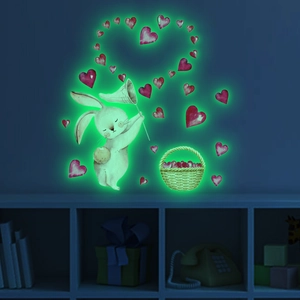 Glow in the dark wall stickers featuring cartoon rabbits and hearts in a kids bedroom