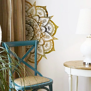Detail of a golden mandala vinyl wall decal with intricate patterns on a living room wall