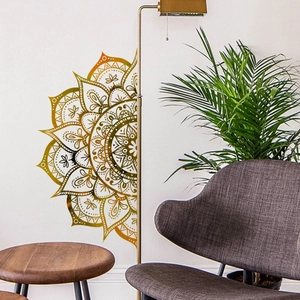 Detailed view of gold mandala wall sticker on white wall in modern living room