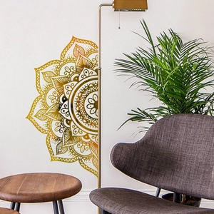 Detailed view of a half-circle gold mandala wall decal in a modern living room setting