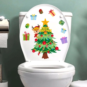Detail view of a Christmas tree and reindeer decal applied to a white toilet lid