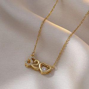 Detailed shot of golden heart pendant with 520 engraving and zircon on champagne silk