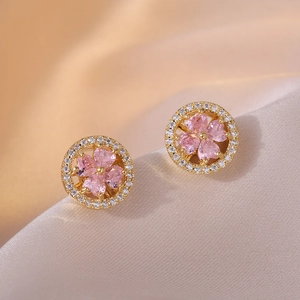 Elegant gold flower earrings with pink zircon petals and pavé crystals on silk