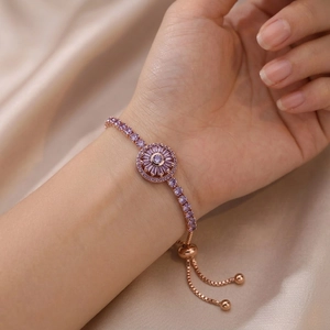 Adjustable rose gold sunflower bracelet with purple zircon stones on silk background