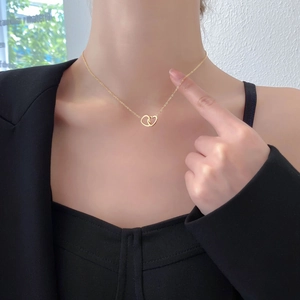 Titanium steel necklace for women featuring a double interlocking heart pendant in gold finish