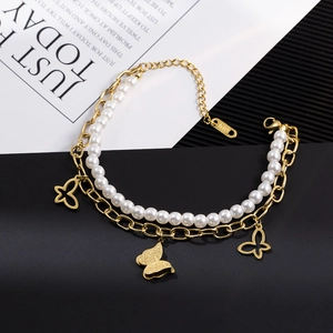 Close-up of double-layer titanium steel bracelet with pearls and butterfly charms