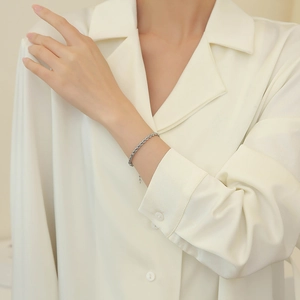 Elegant titanium steel rope chain bracelet worn on a female wrist for a minimalist style