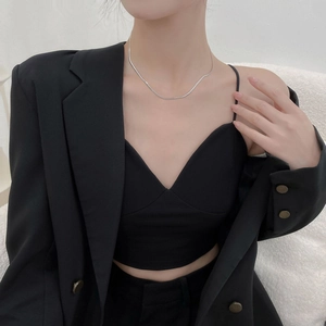 Minimalist flat silver snake chain necklace on female model wearing black suit jacket