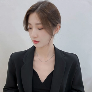 Minimalist silver snake chain necklace on woman in black blazer for elegant daily look