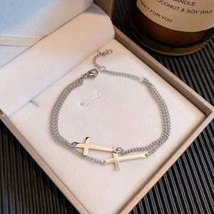 Silver double-layer cross pendant bracelet for women displayed in a premium jewelry box