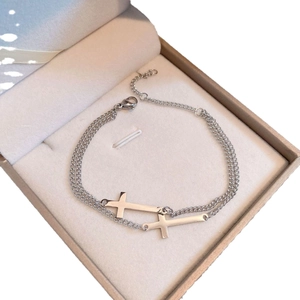 Minimalist double layer silver cross bracelet with adjustable tail chain in a jewelry box