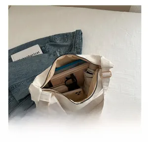 Detailed interior view of a white canvas tote bag showing large capacity for essentials