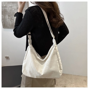 Adjustable wide strap and zipper detail on white soft nylon hobo tote shoulder bag