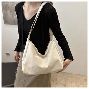 Minimalist ivory crescent tote bag for women featuring a spacious and soft canvas design