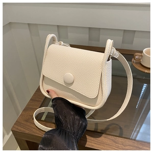 Minimalist cream lychee grain saddle bag with adjustable strap for women crossbody wear