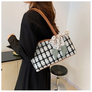 Fashionable black and white tweed plaid tote bag with brown leather strap and decorative scarf