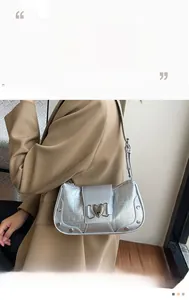 Silver crocodile textured shoulder bag featuring heart buckle and metallic rivets detail