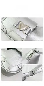 Detailed views of silver crocodile texture bag with heart buckle and metallic hardware