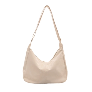 Creamy crescent tote bag with adjustable strap and metal zipper on white background