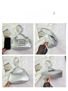 Detail views of silver faux-leather underarm bag with heart buckle and croc-embossed texture