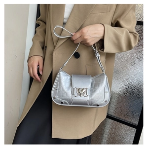 Silver crocodile pattern underarm bag with heart buckle on khaki suit model