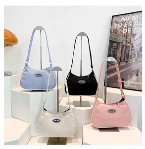 Detailed display of crescent nylon shoulder bags in light blue, black, beige, and pink