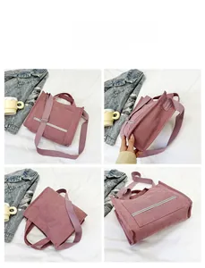 Detail view of corduroy tote bag with reflective strip and crossbody strap in dusty pink