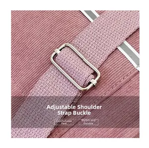 Detail of pink fabric shoulder strap with silver metal adjustment ring and reflective edge