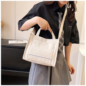 Minimalist beige corduroy tote bag for college students featuring large front pocket detail