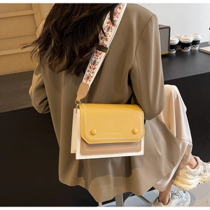 Detailed back view of a contrast color crossbody square bag with wide floral strap