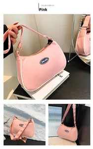 Detail of pink nylon crescent bag with contrast piping and branded SHILAIEN label