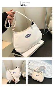 Detailed views of a white nylon crescent shoulder bag featuring brand logo and zipper