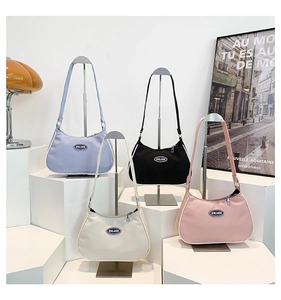 Hobo style nylon underarm bags in multiple colors displayed on white pedestals