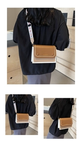 Detail of contrast stitching and geometric print wide strap on brown crossbody bag