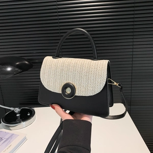 Chic black and white straw contrast crossbody bag with leather handle and top design