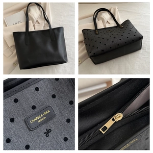 Detail of double-sided tote bag showing polka dot fabric, leather trim and gold zipper