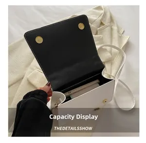 Internal view of a white crossbody bag showing storage space for phone and wallet