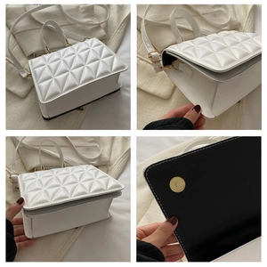 Detail view of white quilted handbag featuring magnetic snap closure and textured leather