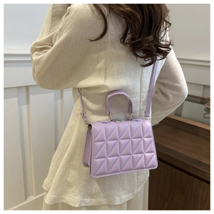 Detailed back view of a light purple quilted mini bag with detachable shoulder strap