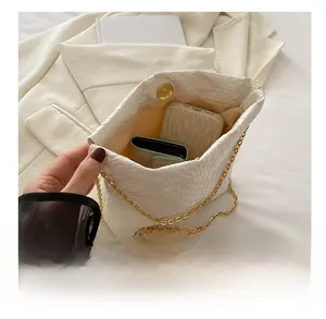 Detail of woven texture shoulder bag showing interior capacity and magnetic closure